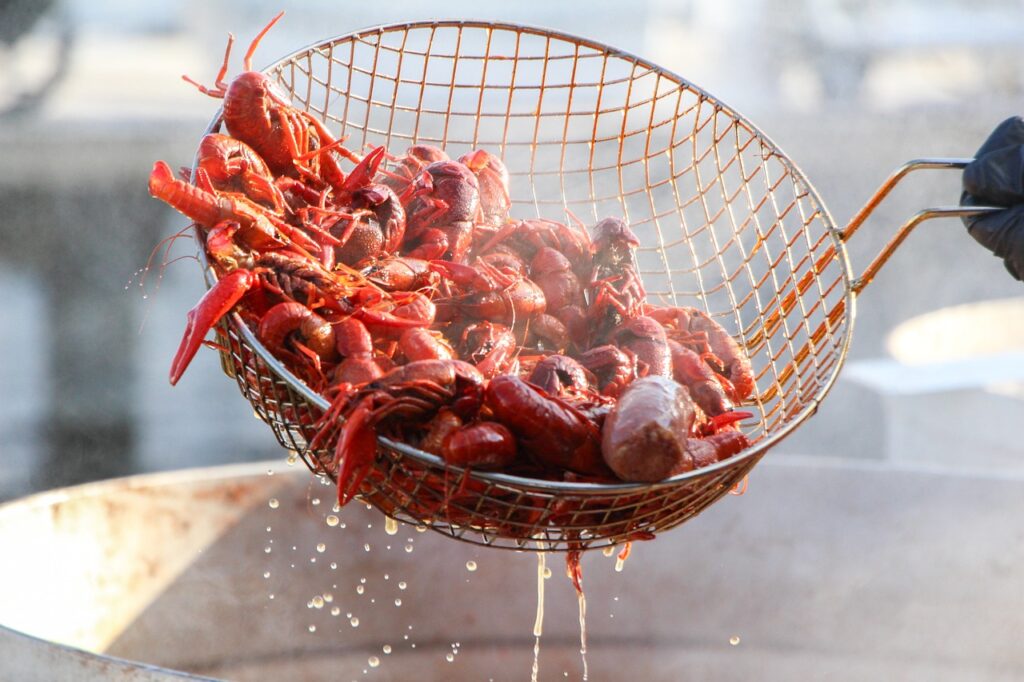 Cooked crawfish in a basket after being pulled from boiling water, a classic Cajun cuisine ingredient