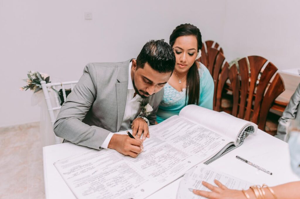 A couple signing papers to buy a house