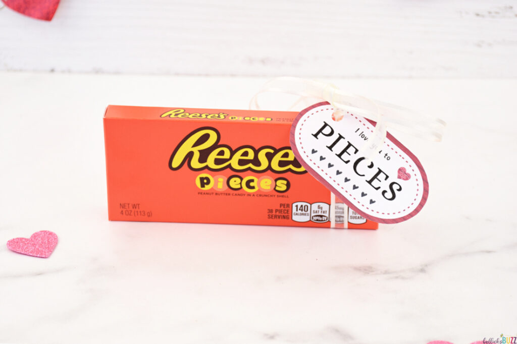 A box of Reese's Pieces with a tag attached saying 'I Love You to Pieces' for the 14 Days of Valentines.