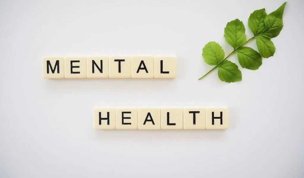 Scrabble blocks spelling out mental health. Here are tips on managing mental health.