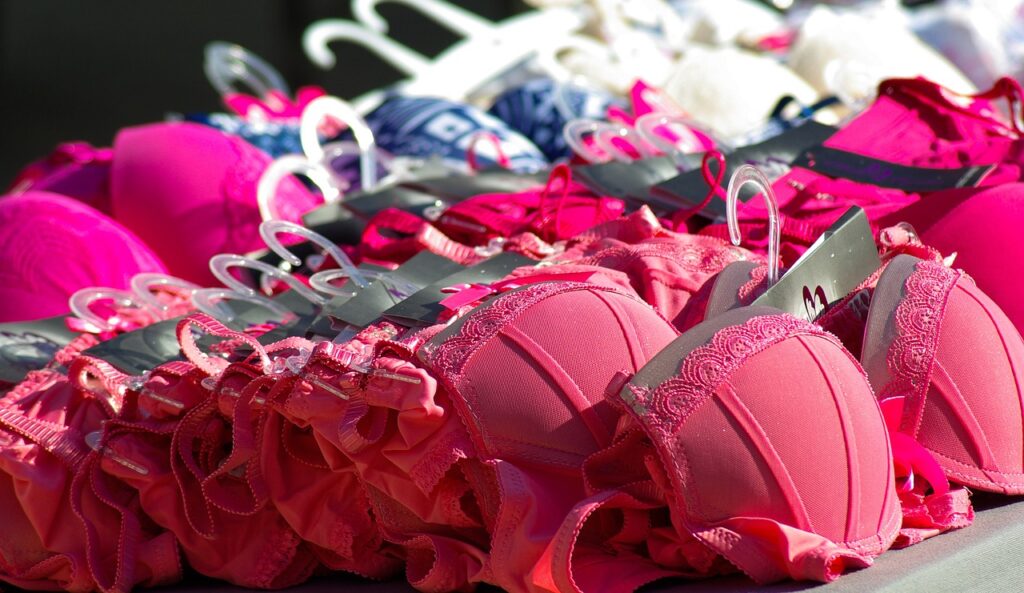 A selection of brightly colored bras on a table. A lot goes into finding the right bra; these tips can help.