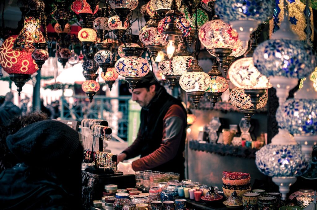 A person selling lamps at a bazaar as part of conscious shopping practices