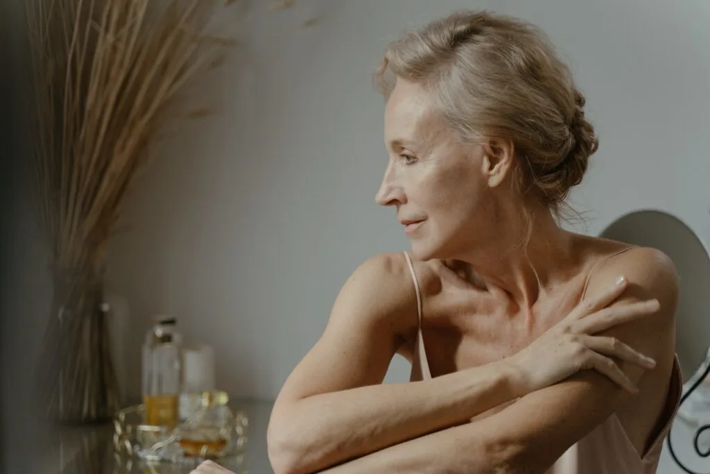A beautiful older woman with glowing skin as a result of a proper skincare routine in your 50s.