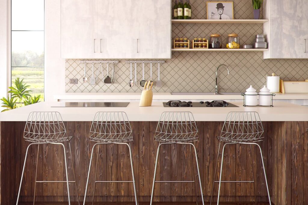 Bar stools in front of a breakfast bar in a modern kitchen. 