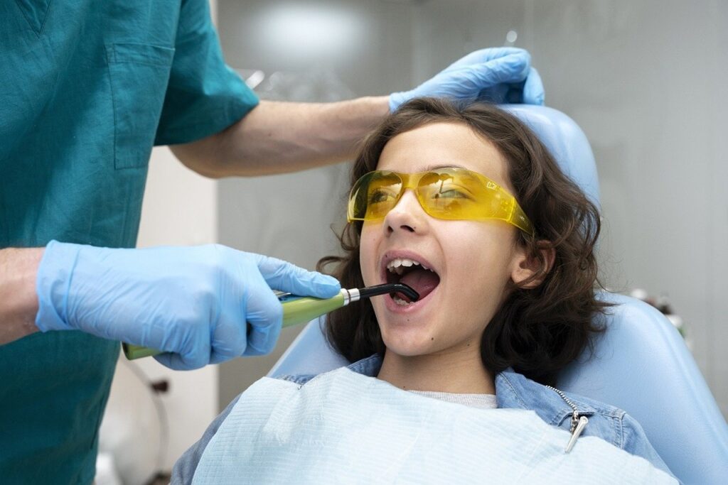 child having teeth cleaned at dentist