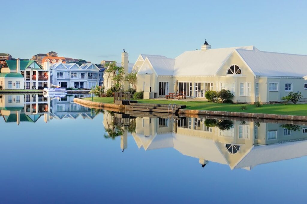 A cream colored house on a waterfront