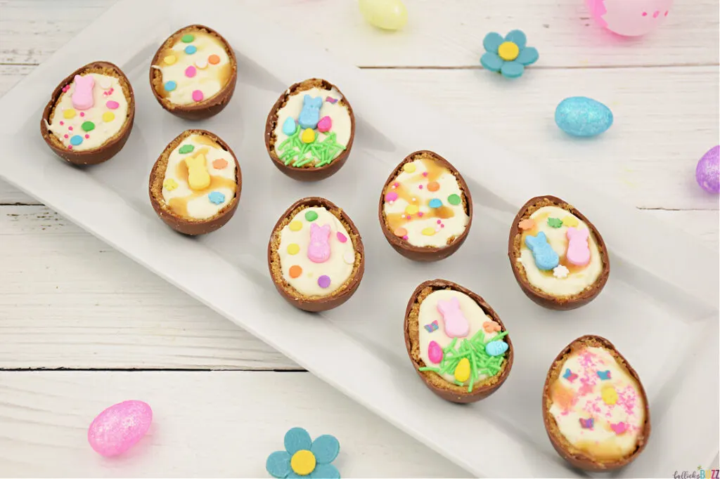 An overhead view of the finished Cheesecake Filled Easter Eggs on a white tray