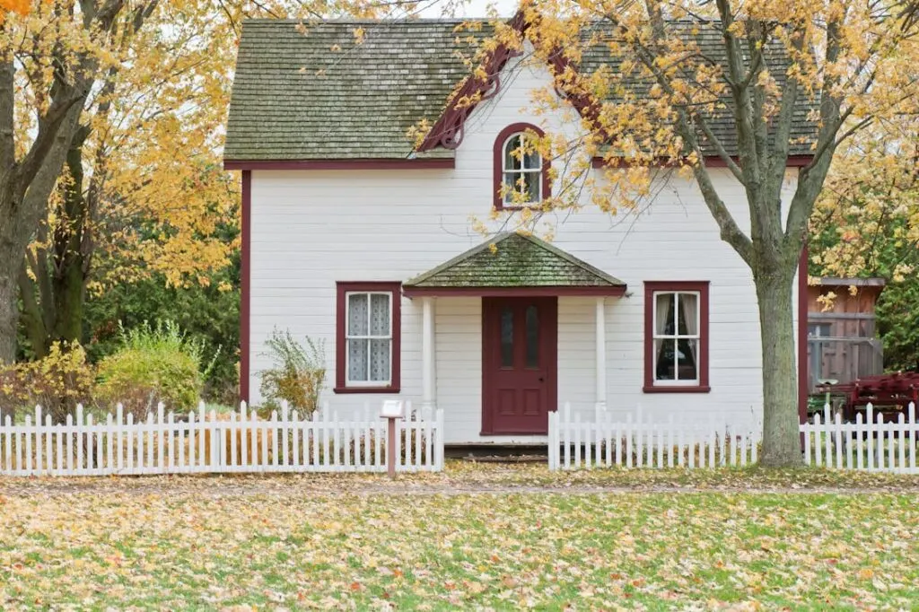 Keep your home looking like this beautiful two story cottage with red trim by following the tips on this homeowners guide to required maintenance.
