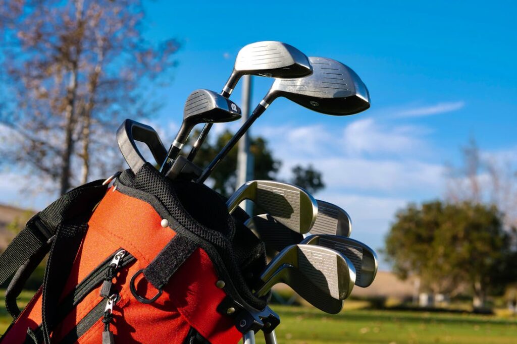 A set of golf clubs in a red and black bag