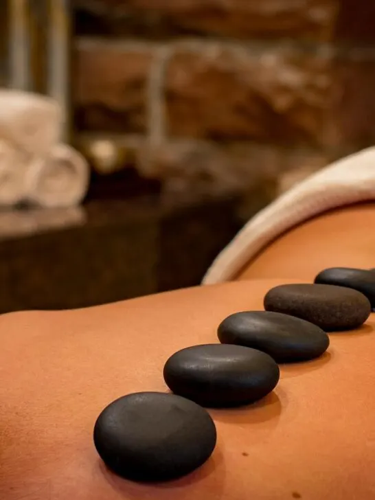 A woman laying on her stomach having a hot rock massage after finding the perfect medical spa for her needs.