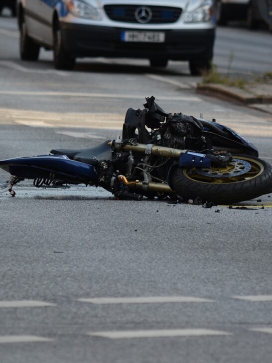 A wrecked motorcycle lying in the road. If this happens to you, use these tips on how to choose the best motorcycle accident lawyer for your case.