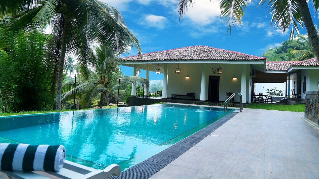 A hotel pool surrounded by palm trees