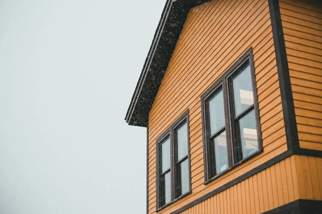 A house with orange siding and brown shutters showing why siding is essential for your home