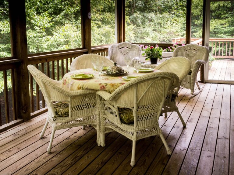 Building a custom deck like this screened in deck with wicker dining set will allow you to enjoy spending more time outside.