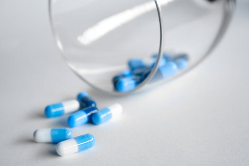 Pills spilling out of a glass representing addiction