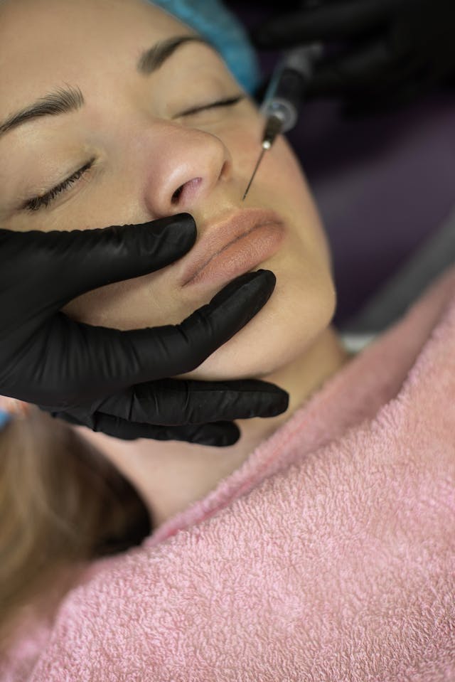 A woman getting Botox injections to cover fine lines