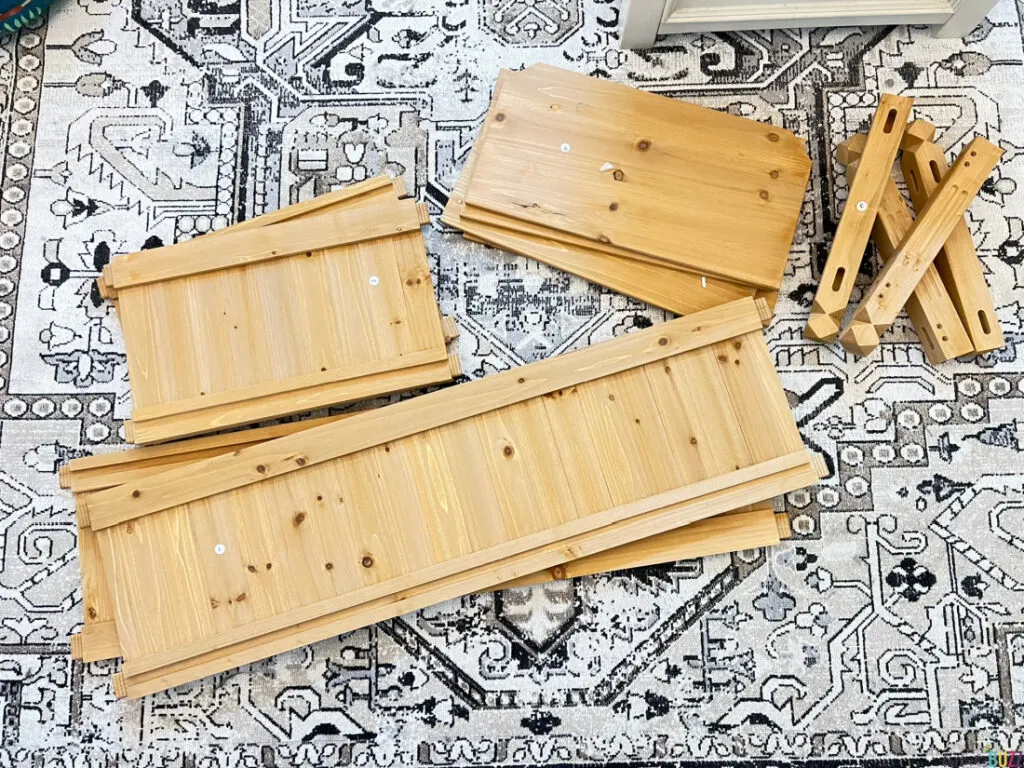 unassembled Yaheetech Planter Box pieces on a rug