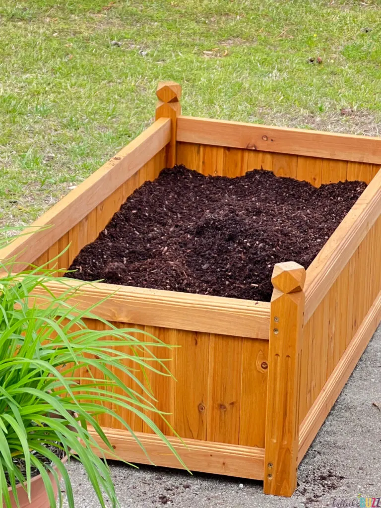 Side view of planter box filled with dirt ready for plants