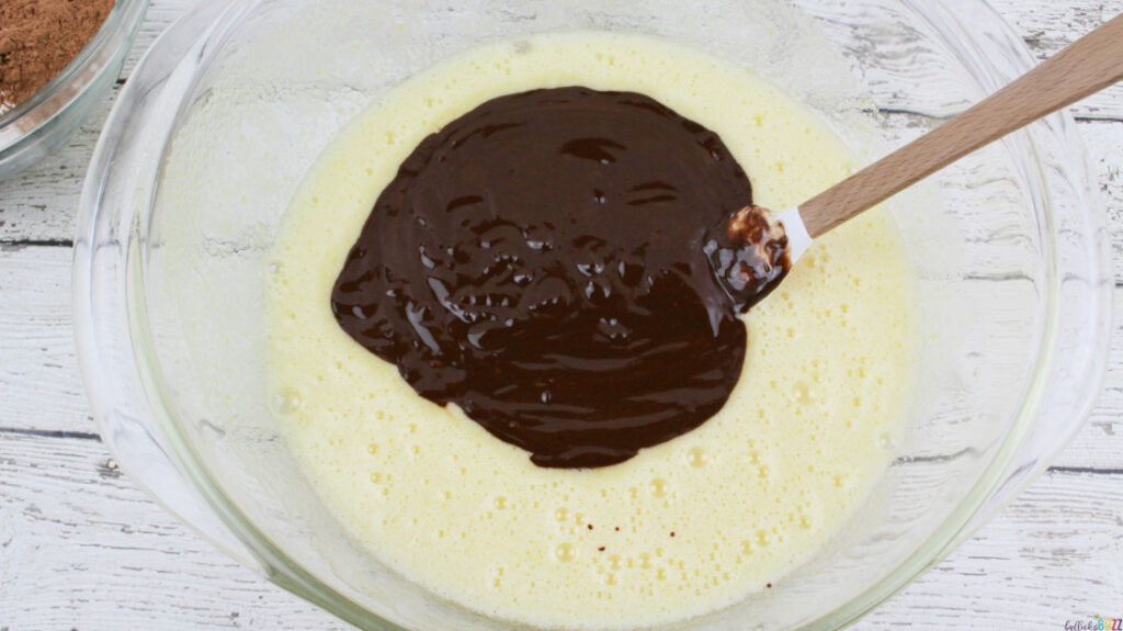 Combining the melted chocolate and butter mixture then stirring well.