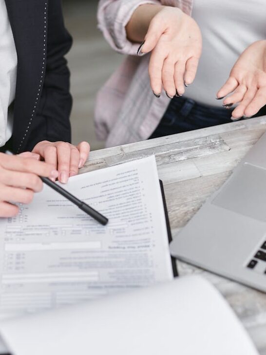 Two people going over the paperwork for qualified mortgages