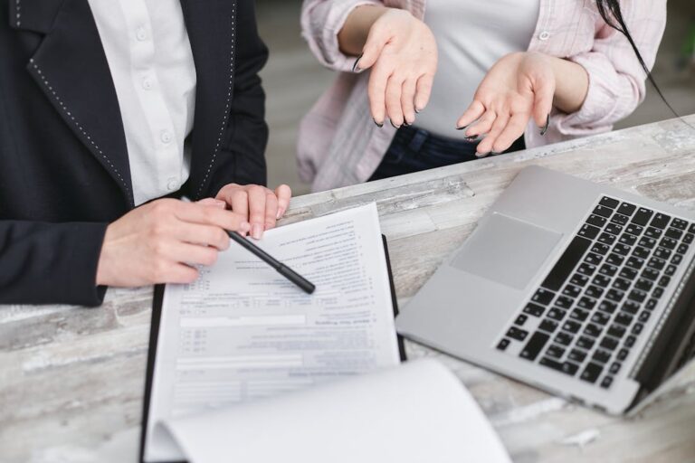 Two people going over the paperwork for qualified mortgages