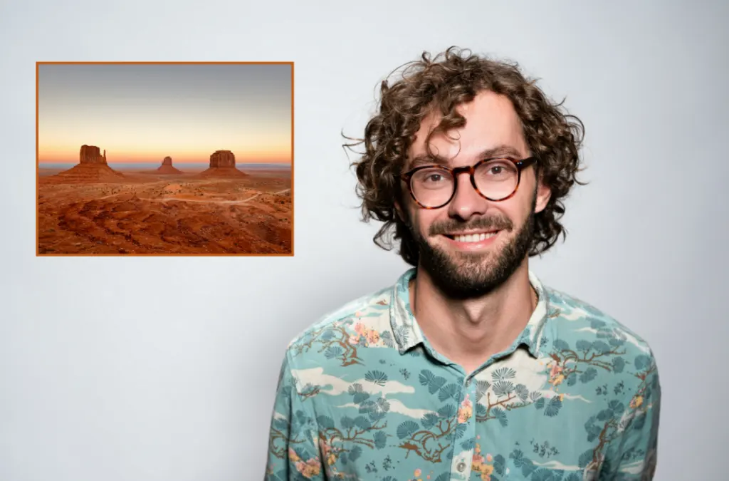 A still shot of a video with a man talking and a photo overlaid in the video to his left