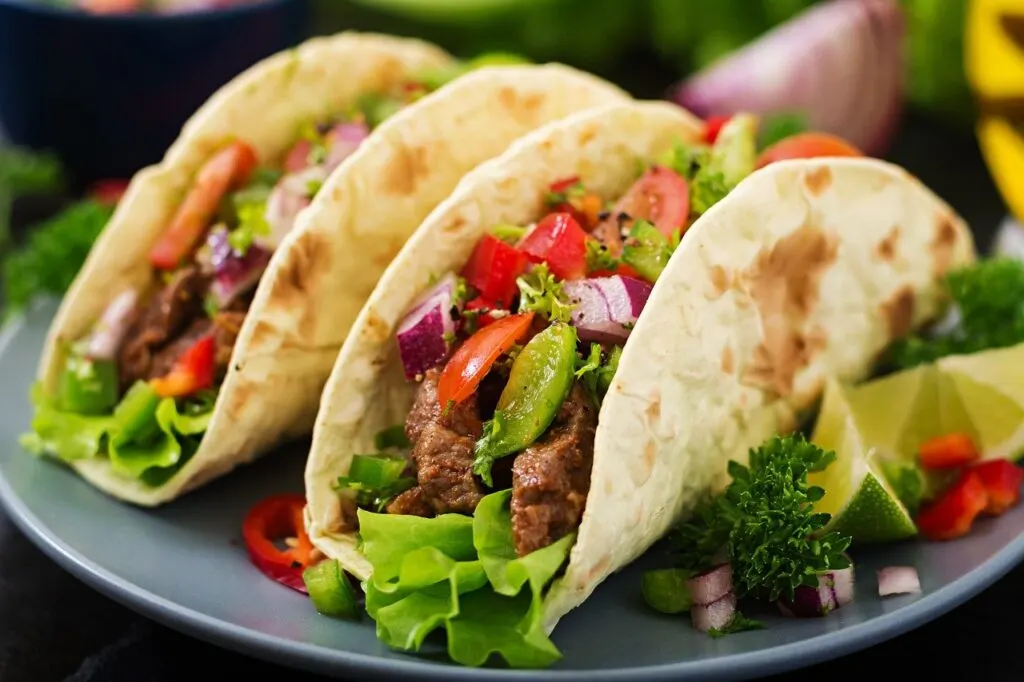Two tacos on a plate are one of the best easy meal ideas for roommates