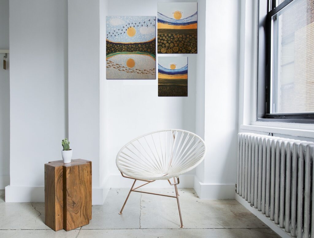 Paintings behind a white chair