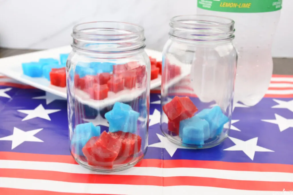 Two  mason jar glasses with jell-O ice cubes in them