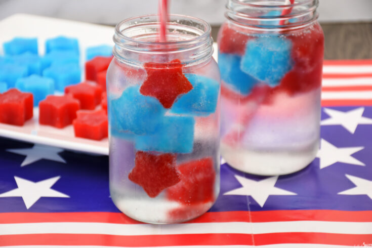 Two mason jar glasses filled with lemon lime soda and easy Jell-O ice cubes