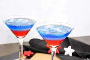 Two red, white and blue cocktails in martini glasses