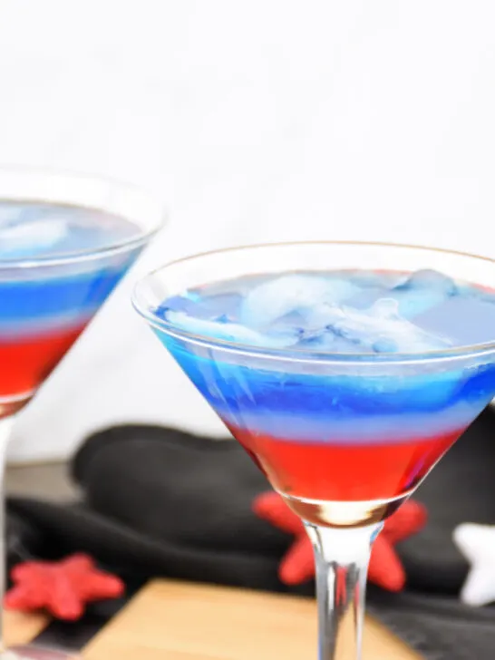 Two red, white and blue cocktails in martini glasses
