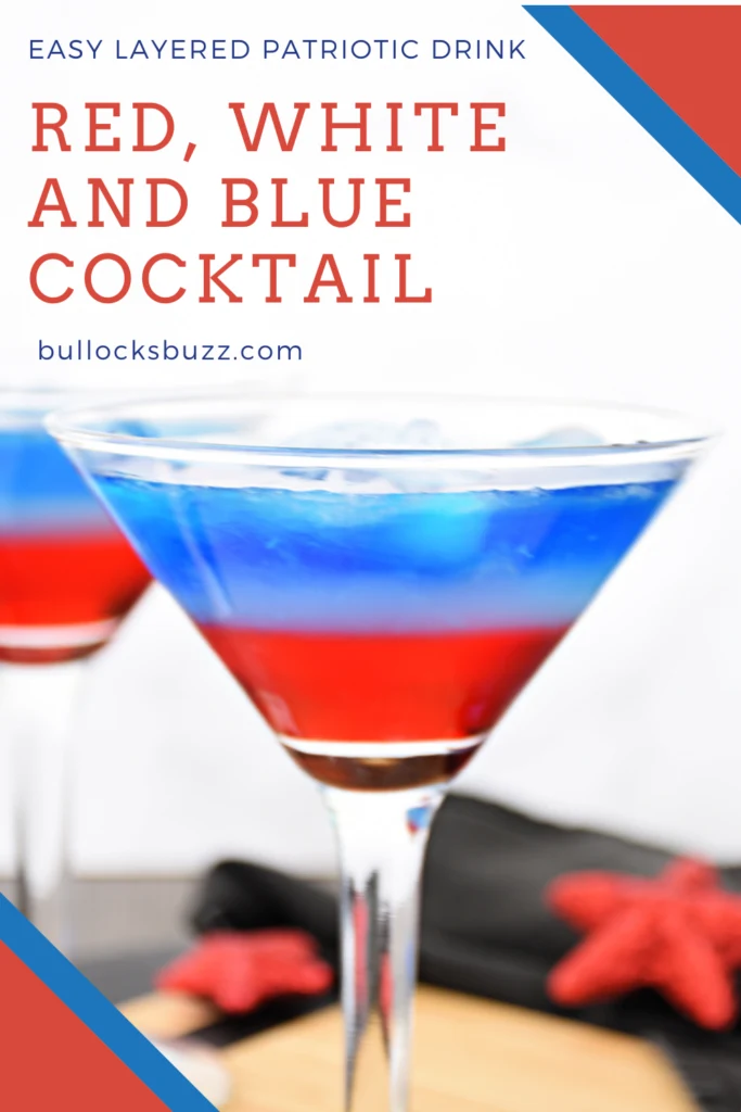 A red, white and blue layered cocktail in a martini glass