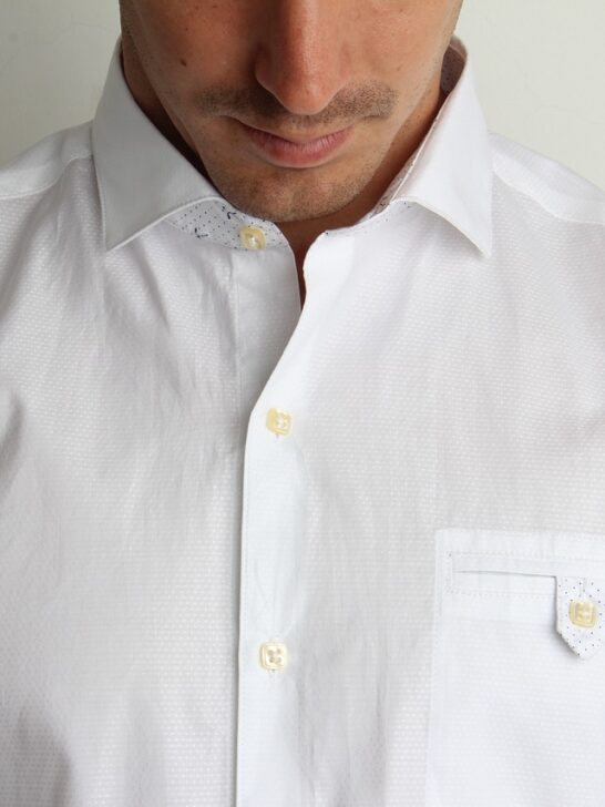 A man wearing a white button up shirt