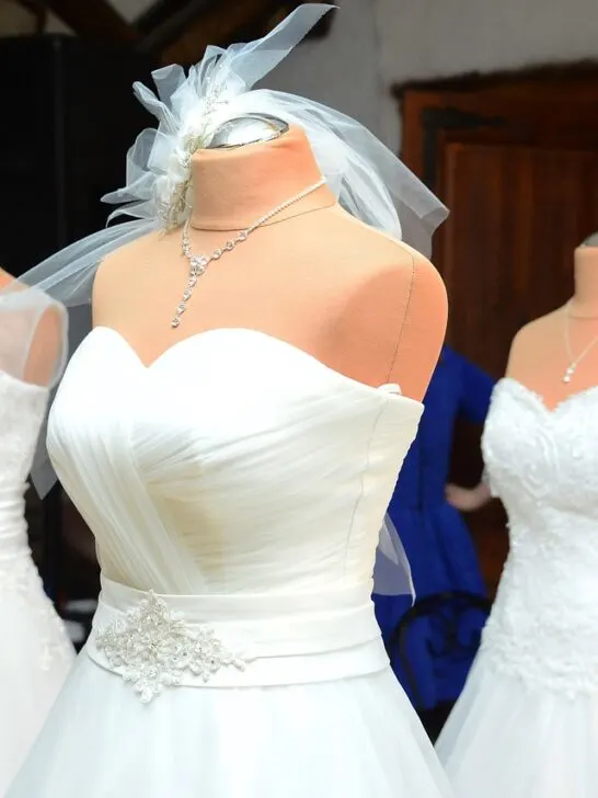 Three wedding gowns on display showing the variety available for finding the perfect wedding dress