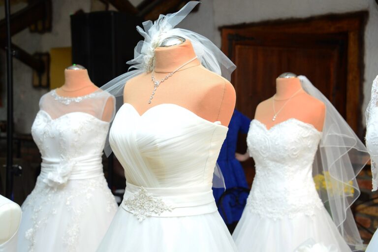 Three wedding gowns on display showing the variety available for finding the perfect wedding dress