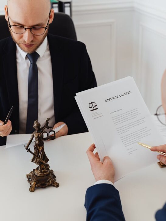 A man reading over a divorce decree with his lawyer as part of the divorce process