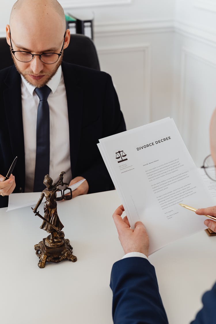 A man reading over a divorce decree with his lawyer as part of the divorce process