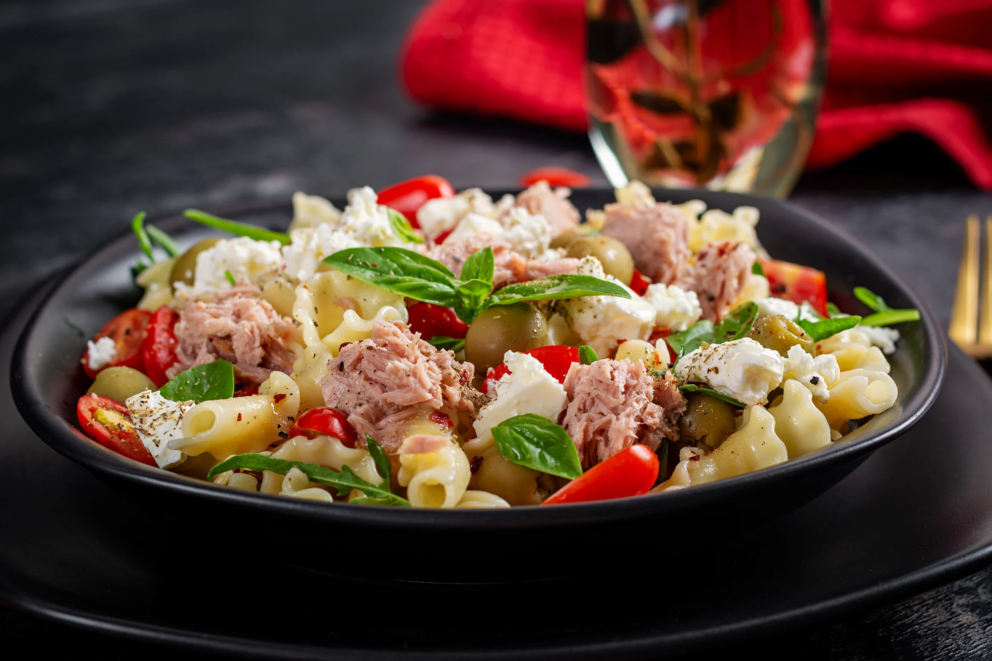 Pasta with tuna, tomatoes and feta cheese. Pasta salad with tuna. Healthy italian food. Healthy dinner.