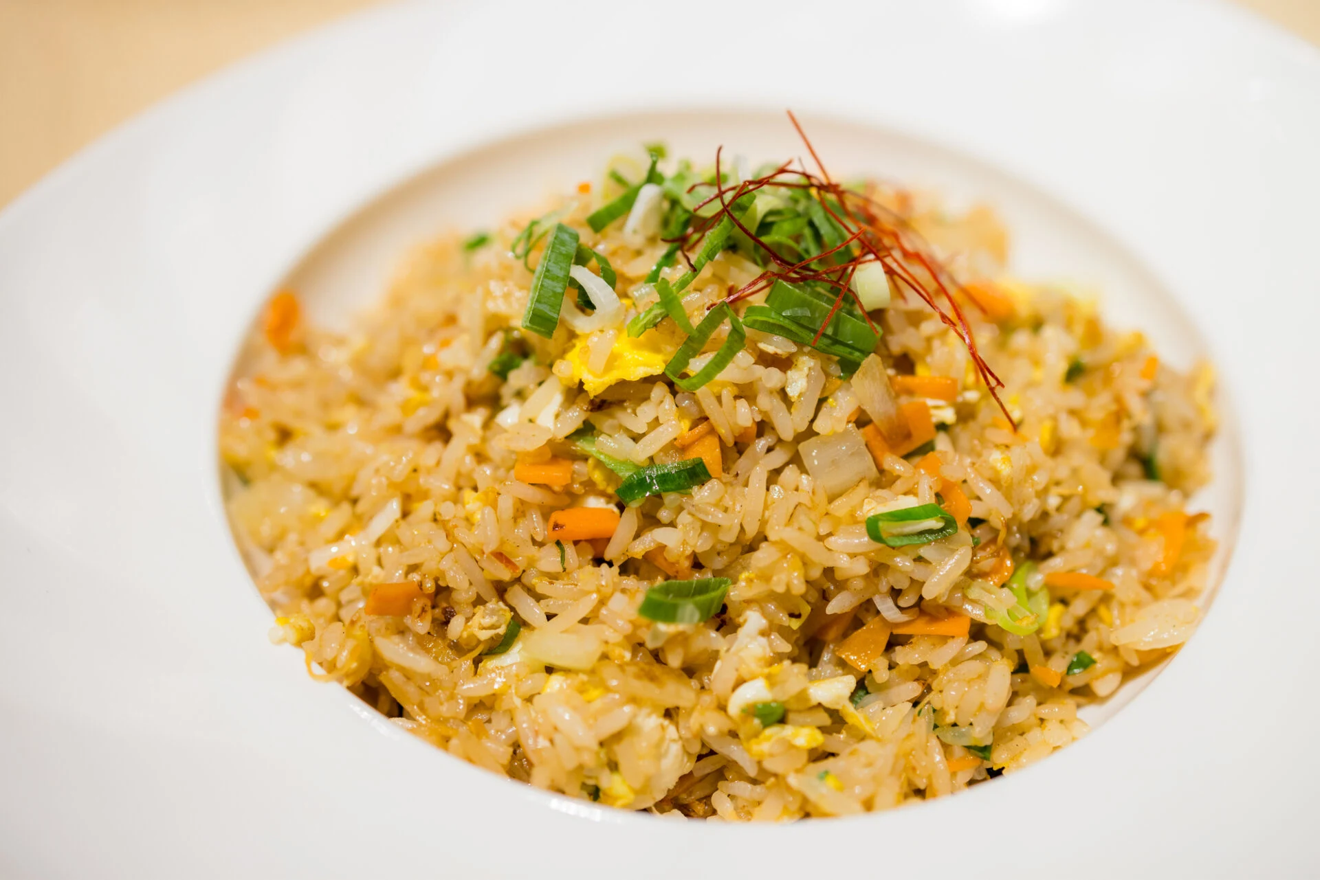 Fried rice on a white plate with dries shrimp