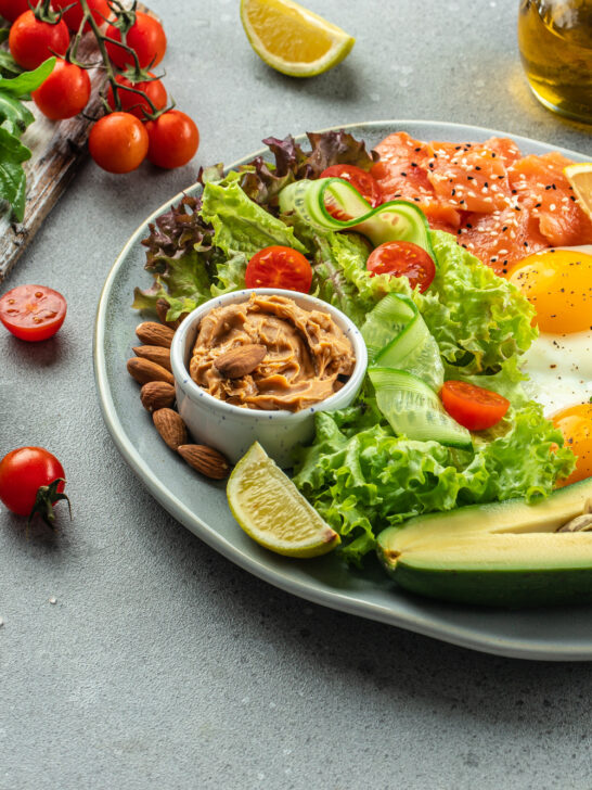 Healthy eating food vegetables salad, avocado, fish, eggs, nuts peanut paste. low carb keto ketogenic diet,