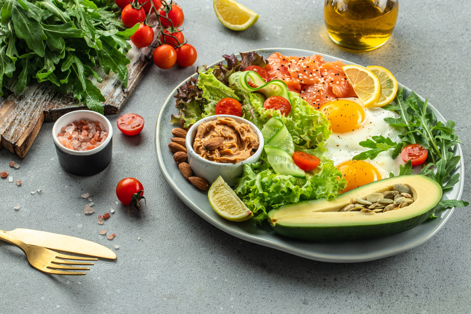 Healthy eating food vegetables salad, avocado, fish, eggs, nuts peanut paste. low carb keto ketogenic diet,