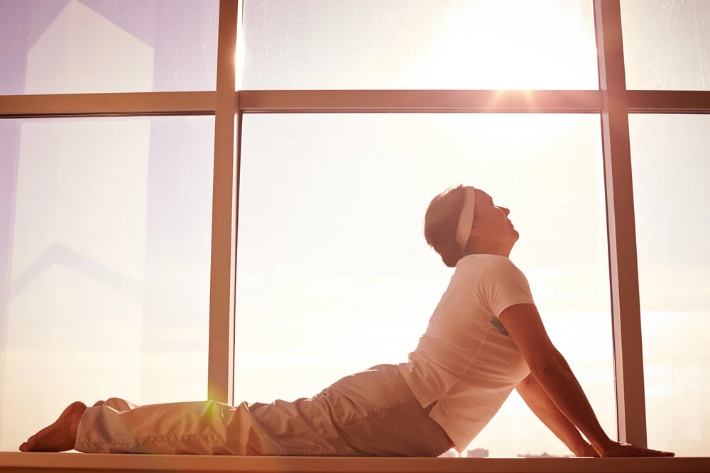 A woman doing yoga which is one of several activities for those with arthritis that can help improve flexibility and pain