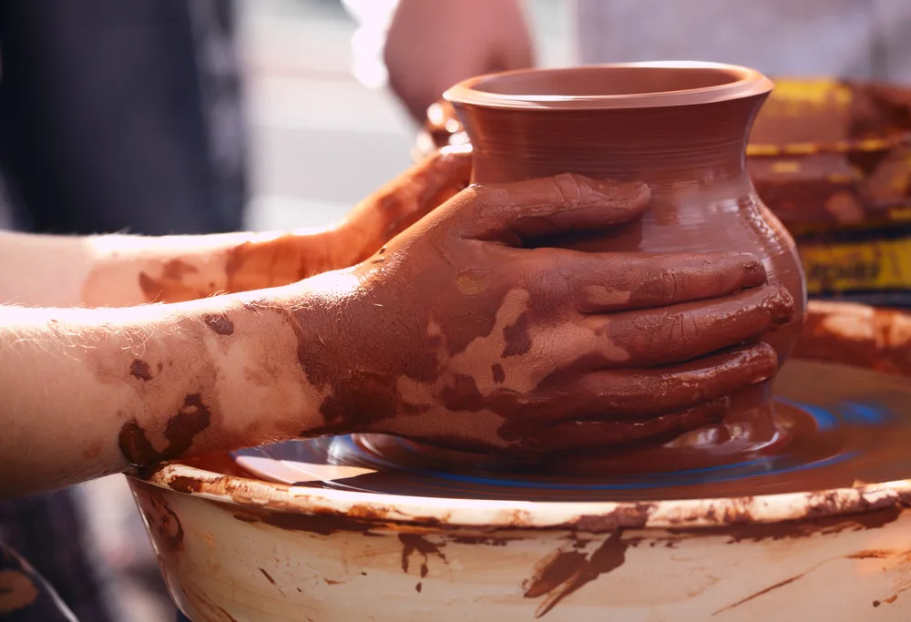 A woman creating a vase on a pottery reel as a cute crafting idea