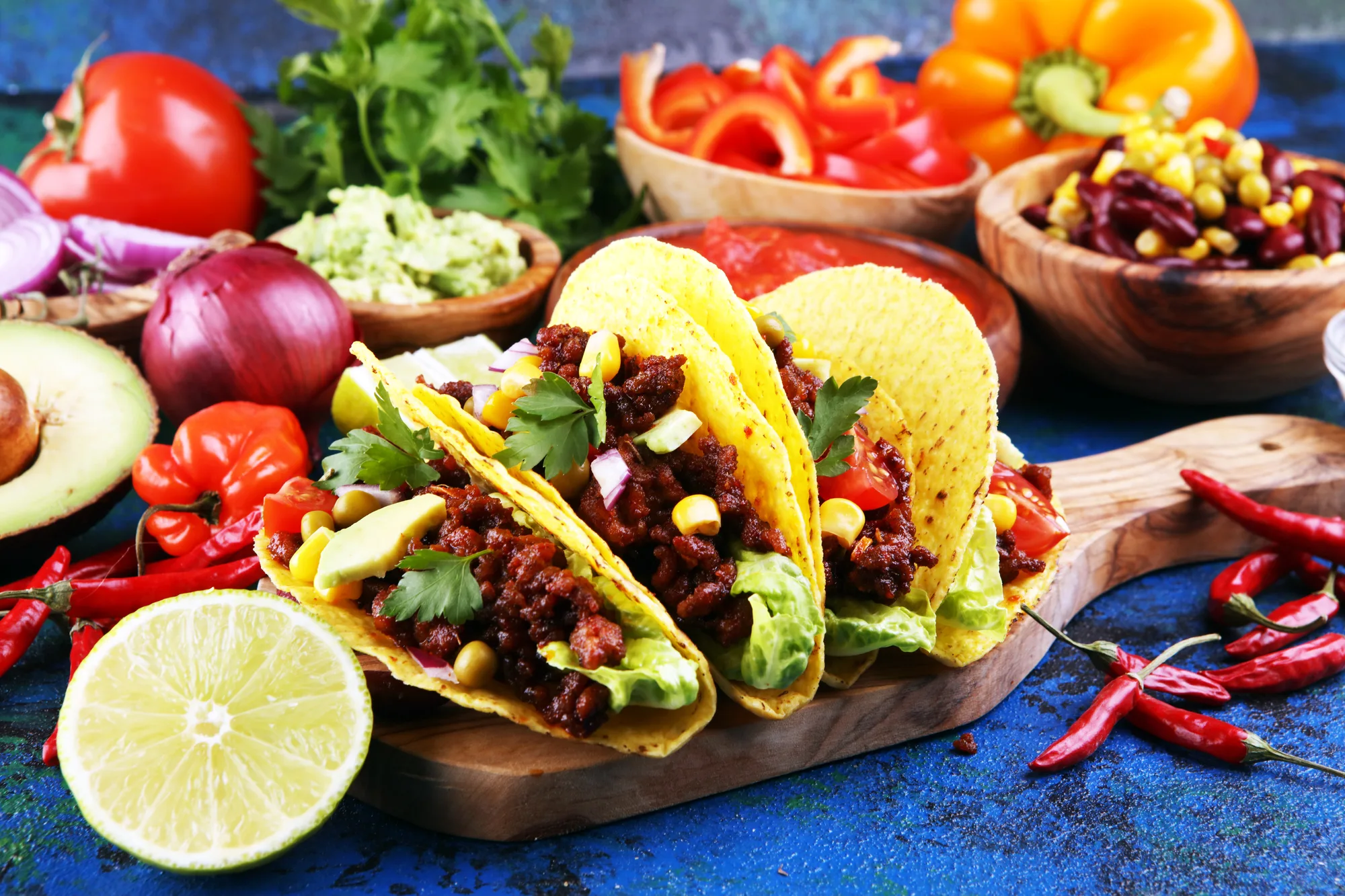 Mexican tacos with beef, tomatoes, avocado, chilli and onions