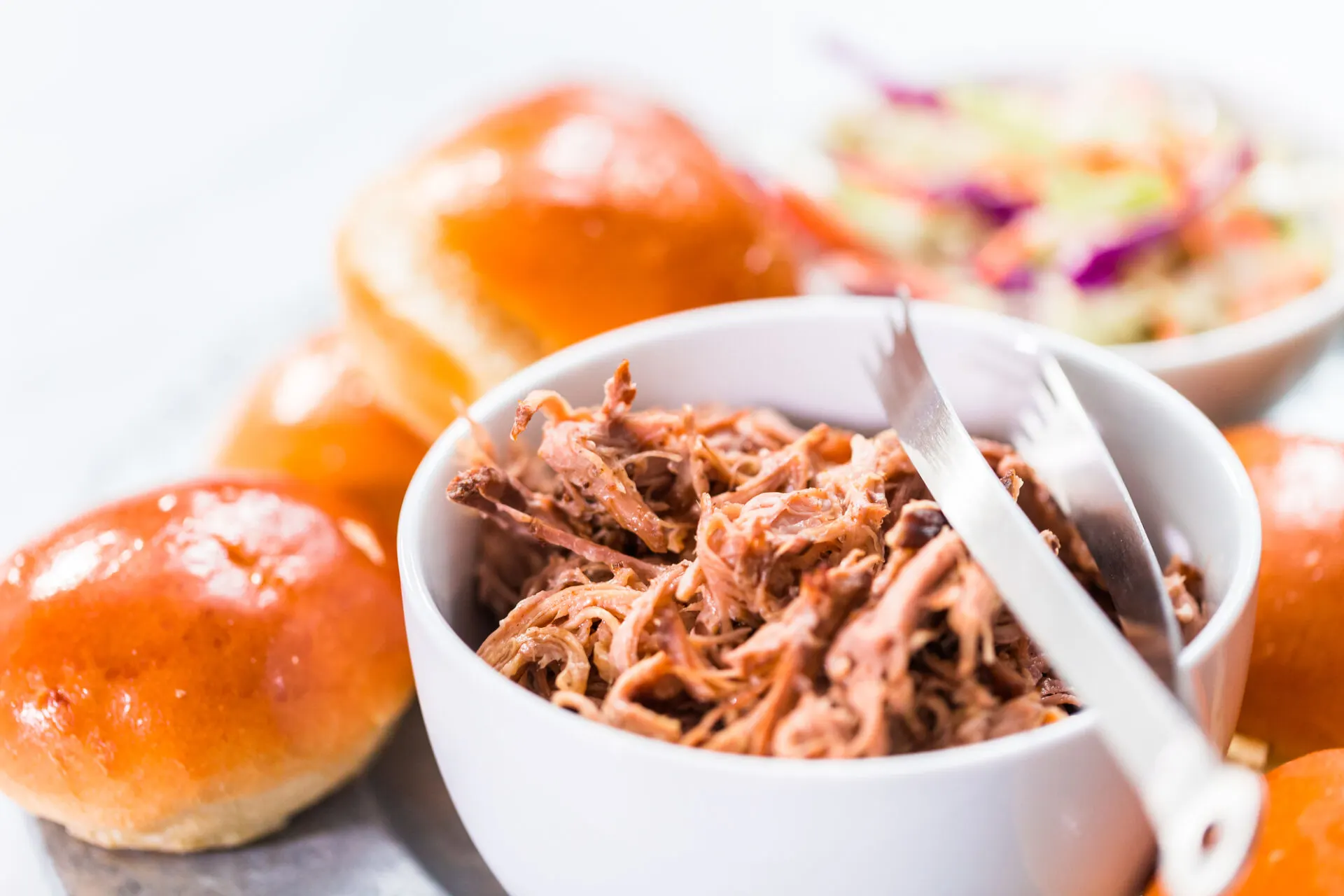 BBQ pulled pork sandwich in shape of small sliders with brioche buns.