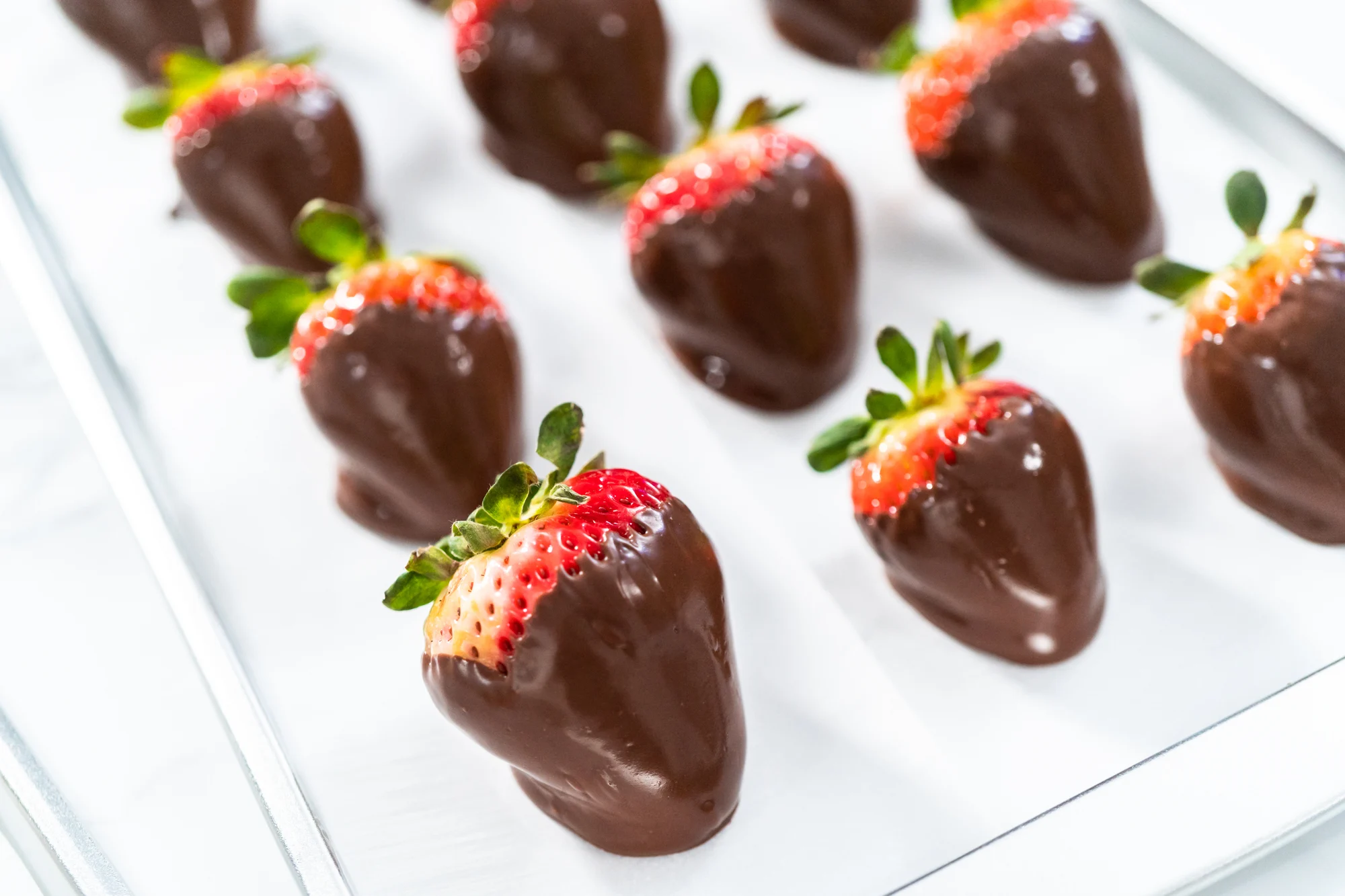 Making white and dark chocolate dipped strawberries.