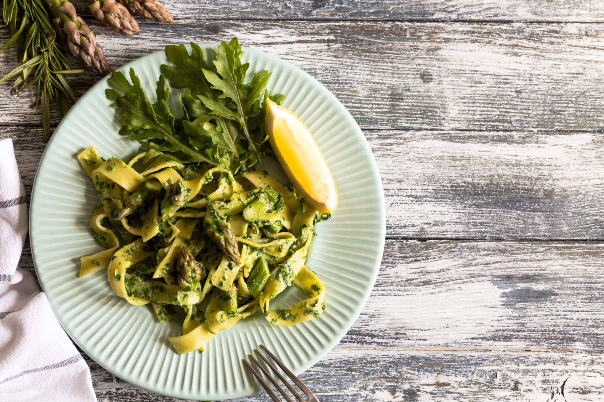 tagliatelle with spinach and asparagus. pasta with cream sauce and vegetables