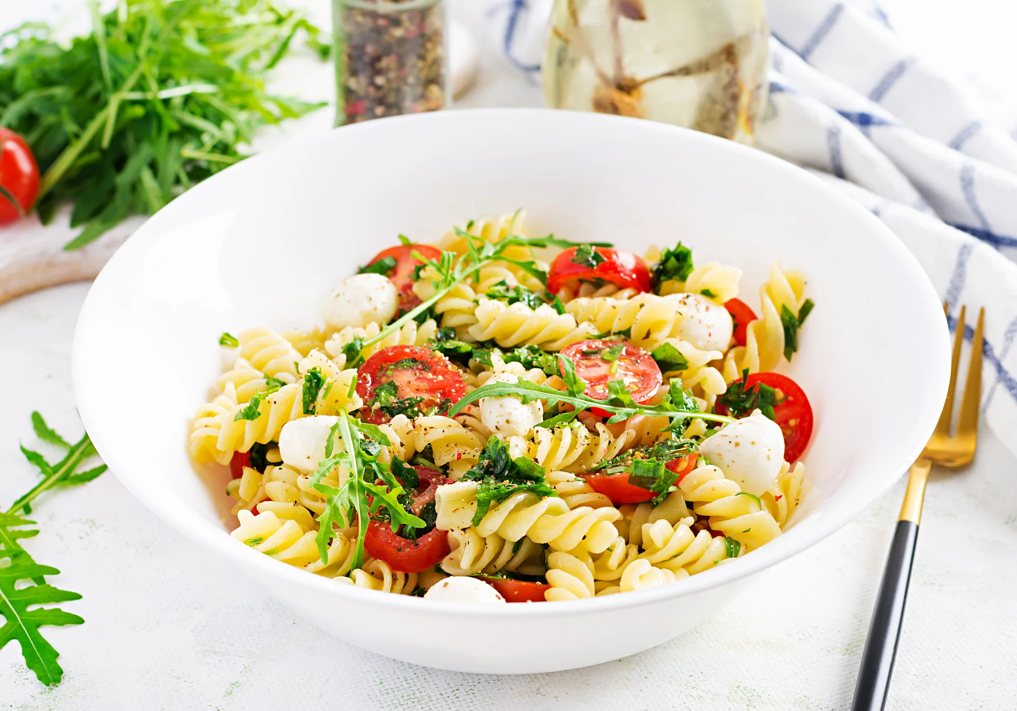 Pasta salad. Fusilli Pasta - Caprese salad with tomato, mozzarella and basil.
