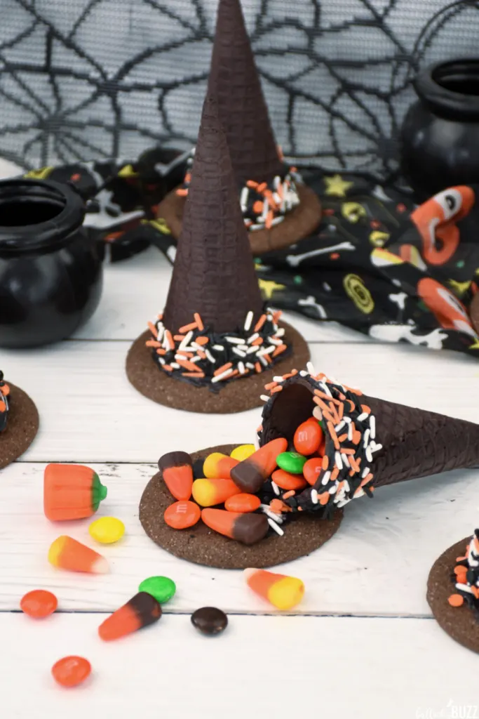 Chocolate ice cream cones filled with candy and turned into witch hats for Halloween party